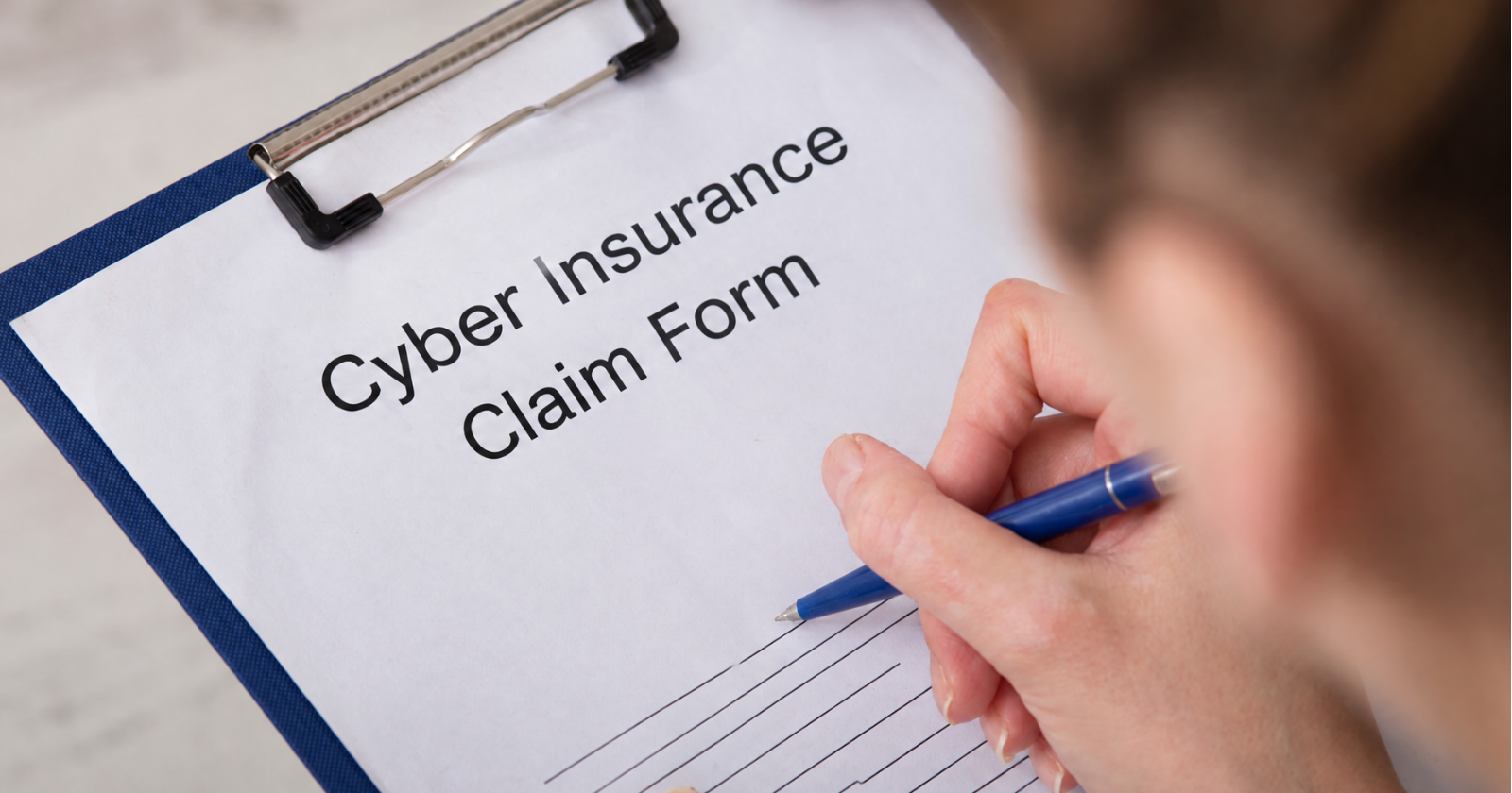 a person filling out a cyber insurance claim form